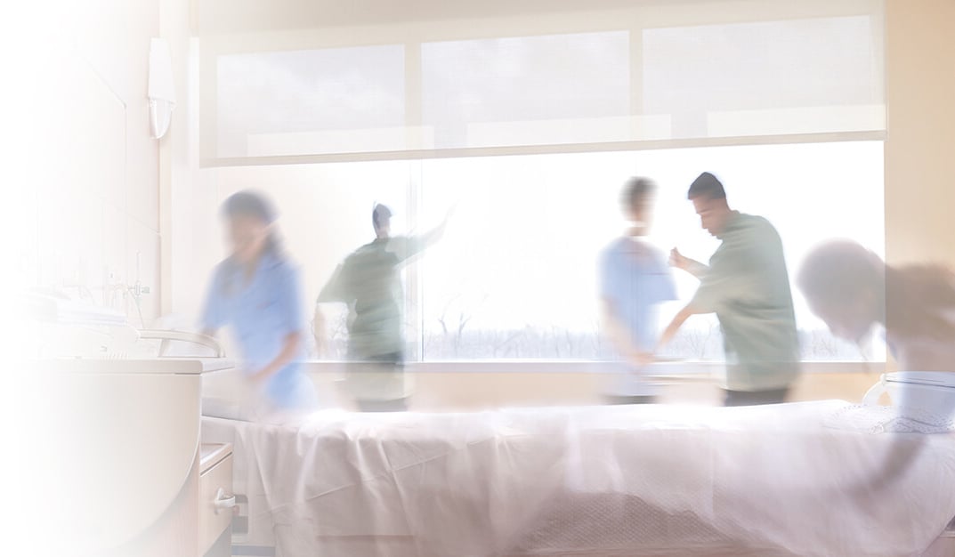 Healthcare workers cleaning hospital room