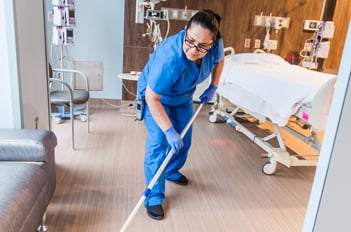 hospital worker cleaning patient room