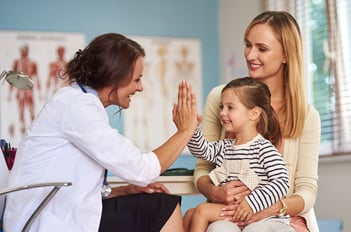 Healthcare employee with pediatric patient